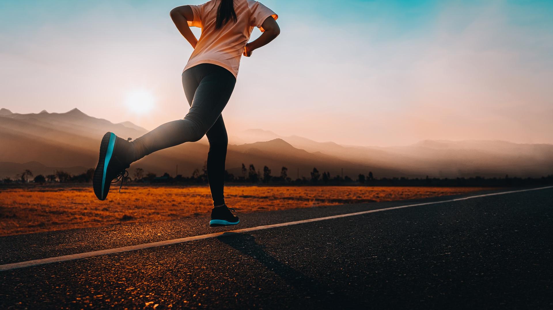Person joggt bei Sonnenuntergang auf Strasse | Barfußschuhe